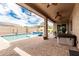 Backyard showcasing a pool, patio area, and outdoor seating at 9390 W Louise Dr, Peoria, AZ 85383