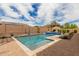 Outdoor pool featuring clear, sparkling water, surrounded by a brick patio, rock landscaping and a covered pergola at 9390 W Louise Dr, Peoria, AZ 85383