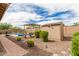 Backyard featuring pool, pergola, landscaping, and a shed, creating a private outdoor retreat with charm and functionality at 9390 W Louise Dr, Peoria, AZ 85383