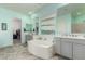 Bright bathroom features a large soaking tub and double sink vanity with generous natural light at 9390 W Louise Dr, Peoria, AZ 85383
