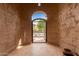 View through wrought iron courtyard gate with unique archway and finished flooring at 9390 W Louise Dr, Peoria, AZ 85383
