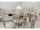 Charming dining area showcasing a glass table, decorative chandelier, and an open view to the living area at 9390 W Louise Dr, Peoria, AZ 85383