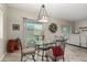 Cozy dining area featuring a decorative chandelier and sliding door access to the backyard pool at 9390 W Louise Dr, Peoria, AZ 85383