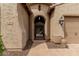 Elegant entryway featuring an arched gate, decorative accents, and a stylish exterior at 9390 W Louise Dr, Peoria, AZ 85383