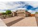 Beautiful home with well-maintained landscaping, a brick driveway, and a two-car garage at 9390 W Louise Dr, Peoria, AZ 85383