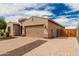 Attractive single-story home with a two-car garage, desert landscaping, and a private fenced side yard at 9390 W Louise Dr, Peoria, AZ 85383