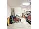 View of garage showing ample space, water heater, storage, and a red bicycle at 9390 W Louise Dr, Peoria, AZ 85383