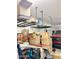 Garage featuring overhead storage racks filled with boxes and assorted items at 9390 W Louise Dr, Peoria, AZ 85383
