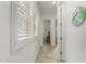 Bright hallway with neutral walls and light-colored tile flooring at 9390 W Louise Dr, Peoria, AZ 85383