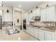 Bright kitchen featuring stainless steel appliances, light-colored cabinets, and a large island with sink at 9390 W Louise Dr, Peoria, AZ 85383