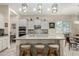 Bright kitchen with an island, breakfast bar and stylish lighting fixture at 9390 W Louise Dr, Peoria, AZ 85383