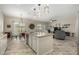 Open-concept kitchen with a central island and seamless connection to the dining and living areas at 9390 W Louise Dr, Peoria, AZ 85383