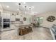 Well-lit kitchen featuring an island with barstool seating, and modern appliances at 9390 W Louise Dr, Peoria, AZ 85383
