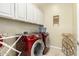 Laundry room with modern washer and dryer and ample storage at 9390 W Louise Dr, Peoria, AZ 85383