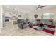 Open-concept living room boasts a ceiling fan, tile floors, and flows into the kitchen at 9390 W Louise Dr, Peoria, AZ 85383