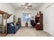 Bright living room with comfortable seating and a small office area, providing ample space at 9390 W Louise Dr, Peoria, AZ 85383