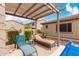 Relaxing patio space featuring lounge chairs, a pergola, and a cozy outdoor ambiance, perfect for leisure at 9390 W Louise Dr, Peoria, AZ 85383