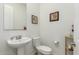 Powder room featuring a pedestal sink, toilet and neutral walls at 9390 W Louise Dr, Peoria, AZ 85383
