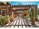 Outdoor kitchen and patio with fireplace, grill, and desert landscaping at 13450 E Via Linda St # 1019, Scottsdale, AZ 85259