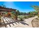 Cozy outdoor patio with fireplace, grill and pool view with desert landscaping at 13450 E Via Linda St # 1019, Scottsdale, AZ 85259