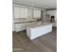 Bright kitchen featuring white cabinets, a center island, and stainless steel faucet at 2467 W Rowel Rd, Phoenix, AZ 85085