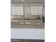 Close up view of kitchen island with sink and pull-down faucet at 2467 W Rowel Rd, Phoenix, AZ 85085