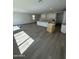 Spacious open-concept living area with a kitchen and wood-style flooring at 2467 W Rowel Rd, Phoenix, AZ 85085