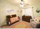 Bright and cozy Bedroom decorated with cheerful wallpaper and a comfortable rocking chair at 520 E Appaloosa Rd, Gilbert, AZ 85296