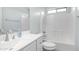 Well-lit bathroom features a sink with a vanity, toilet, and bathtub with white tiling and shower at 6092 S Bridal Vail Dr, Gilbert, AZ 85298