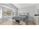 Bedroom with tray ceilings, a gray bed, and a large window with blinds at 6092 S Bridal Vail Dr, Gilbert, AZ 85298