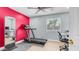 This home bedroom has a treadmill, desk, chair, colorful walls, window with blinds and carpet at 6092 S Bridal Vail Dr, Gilbert, AZ 85298