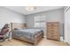 This bedroom has gray walls, light-colored floors, a bed, a nightstand, and a window with blinds at 6092 S Bridal Vail Dr, Gilbert, AZ 85298