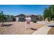 Charming single-story home with a well-maintained front yard, desert landscaping, and a two-car garage at 6092 S Bridal Vail Dr, Gilbert, AZ 85298