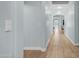 Bright hallway featuring wood floors and neutral paint, leading to other rooms in the home at 6092 S Bridal Vail Dr, Gilbert, AZ 85298