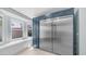 A kitchen with stainless steel refrigerator, blue cabinets, and a window with bench at 6092 S Bridal Vail Dr, Gilbert, AZ 85298