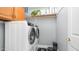 Efficient laundry room with modern washer and dryer, cabinet storage, and a robot vacuum at 6092 S Bridal Vail Dr, Gilbert, AZ 85298