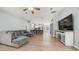 Open concept living room with vaulted ceiling, ceiling fan, and gray sectional sofa at 6092 S Bridal Vail Dr, Gilbert, AZ 85298