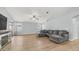 Spacious living room with wood flooring, a ceiling fan and sliding glass door access at 6092 S Bridal Vail Dr, Gilbert, AZ 85298