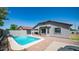This backyard pool has bright blue water, a patio area, backyard trees, and a patio deck at 6092 S Bridal Vail Dr, Gilbert, AZ 85298