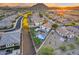 Scenic aerial view showcasing a home's backyard oasis with a sparkling pool and verdant putting green at 18103 W Canyon Ln, Goodyear, AZ 85338