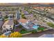 Scenic aerial view showcasing a home's backyard oasis with a sparkling pool and verdant putting green at 18103 W Canyon Ln, Goodyear, AZ 85338