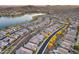 Beautiful aerial view of homes near a lake showcasing landscaping, pools, and community amenities at 18103 W Canyon Ln, Goodyear, AZ 85338