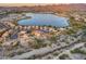 Stunning aerial view of lakeside homes showcasing community amenities and picturesque mountain backdrop at 18103 W Canyon Ln, Goodyear, AZ 85338