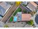 Drone eye view featuring a backyard oasis with a pool, putting green, and outdoor kitchen area at 18103 W Canyon Ln, Goodyear, AZ 85338
