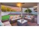 Inviting covered back patio with putting green and comfortable wicker furniture; perfect for relaxation at 18103 W Canyon Ln, Goodyear, AZ 85338