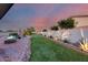 Backyard showcasing pool, putting green, desert landscaping, and a private outdoor retreat at 18103 W Canyon Ln, Goodyear, AZ 85338