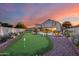 Lush backyard boasts putting green, pool, and private outdoor retreat at 18103 W Canyon Ln, Goodyear, AZ 85338
