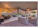 Spacious covered patio overlooking pool, fire pit, and putting green creates an outdoor oasis at 18103 W Canyon Ln, Goodyear, AZ 85338