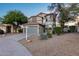 Charming two-story home featuring desert landscaping, a two car garage and neutral exterior paint at 18103 W Canyon Ln, Goodyear, AZ 85338