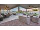 Spacious covered patio with seating, dining area, and view of the sparkling pool at 18103 W Canyon Ln, Goodyear, AZ 85338